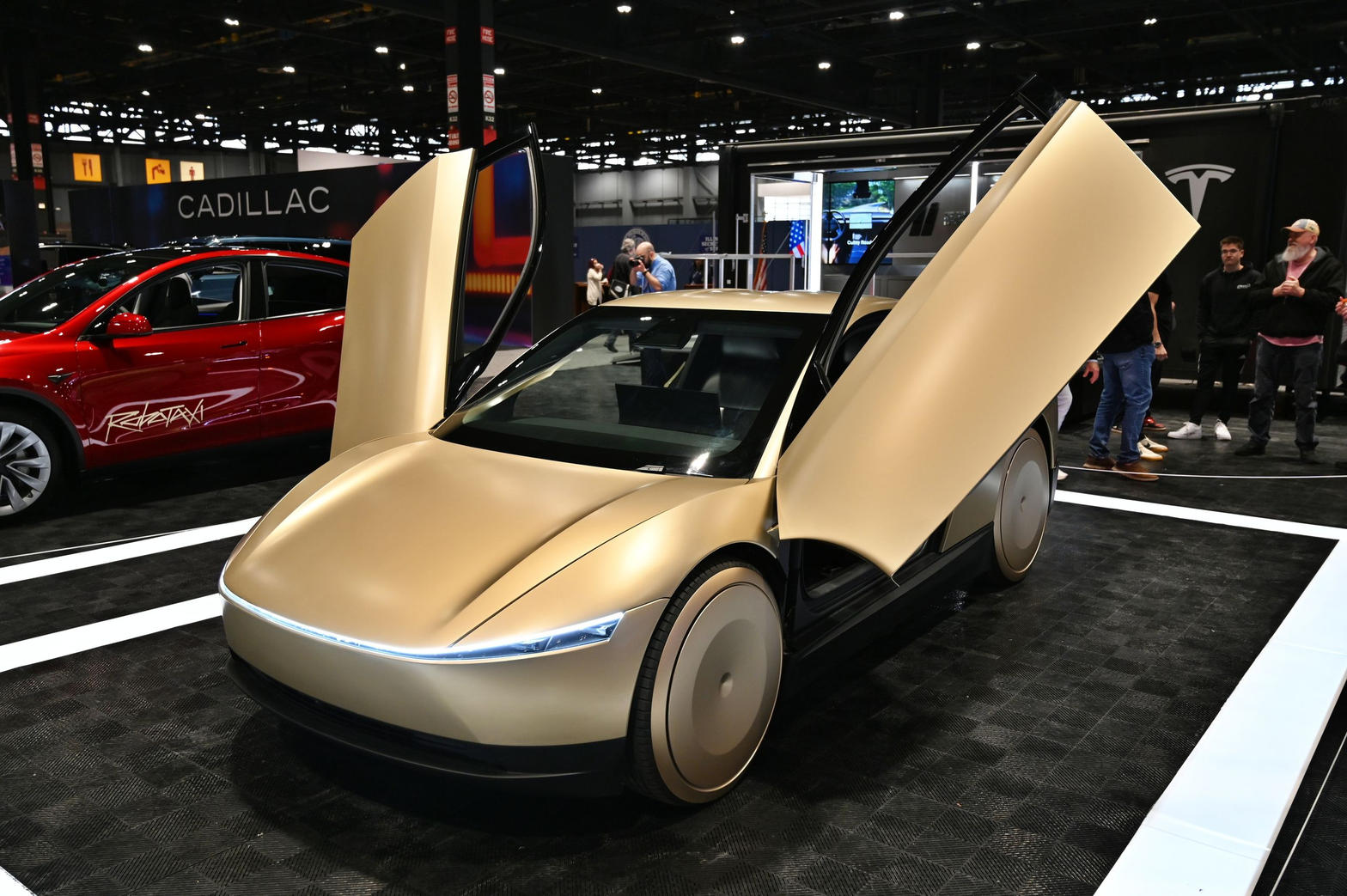 Tesla Cybercab production vehicle with falcon-wing doors raised
