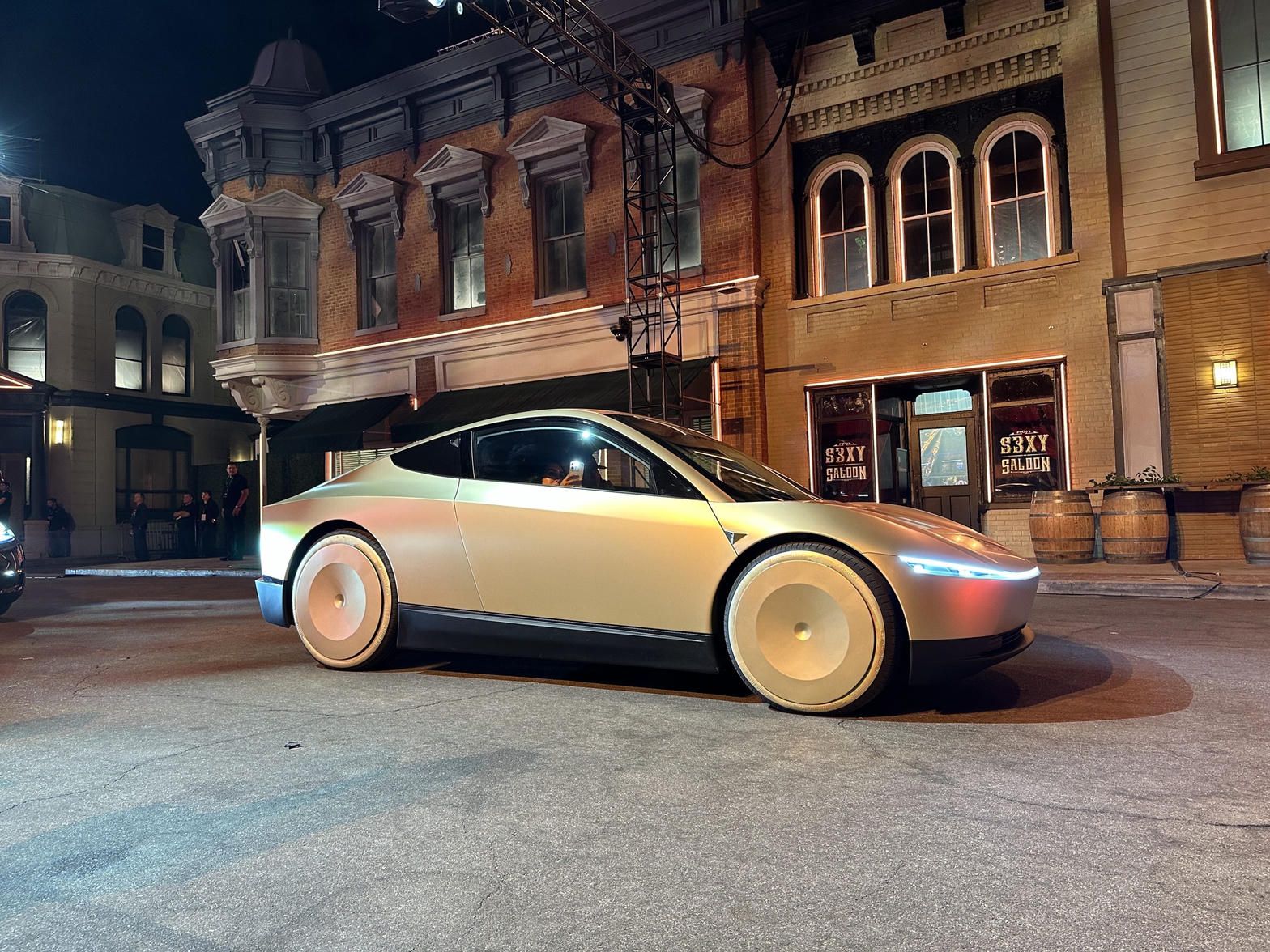 Gold Tesla Cybercab on a night street